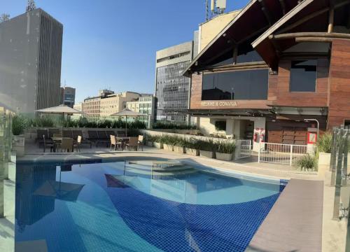 a large swimming pool in front of a building at Studio Mauá 705 in Rio de Janeiro