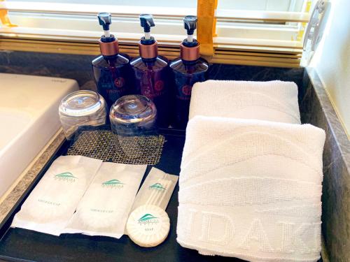 a tray with toilet paper and bottles of wine at Andakira Hotel - SHA Extra Plus in Patong Beach