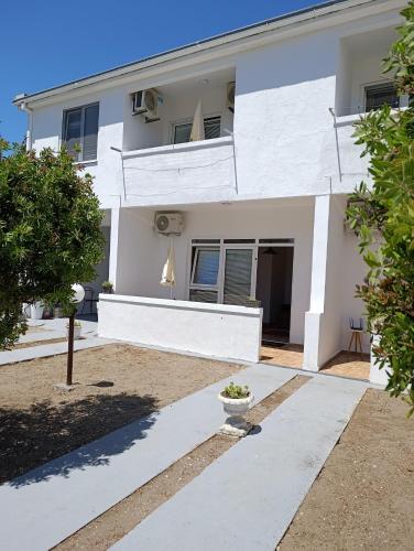 a white house with a tree in front of it at Villa Serenita in Ulcinj