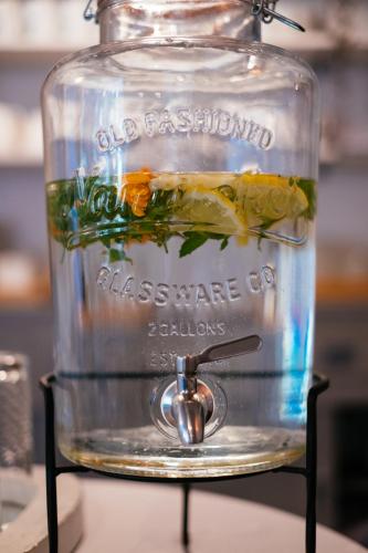 a glass jar filled with water and vegetables at Tŷ Afon - River House in Beddgelert