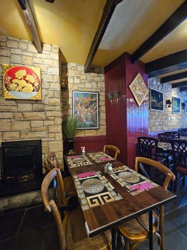 a dining room with a table and a fireplace at Listowel Town in Listowel