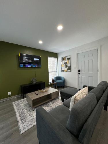 a living room with a couch and a table at 2 STATE FAIR l DT Dallas l FIFA READY l 5 Min from Love Field in Dallas