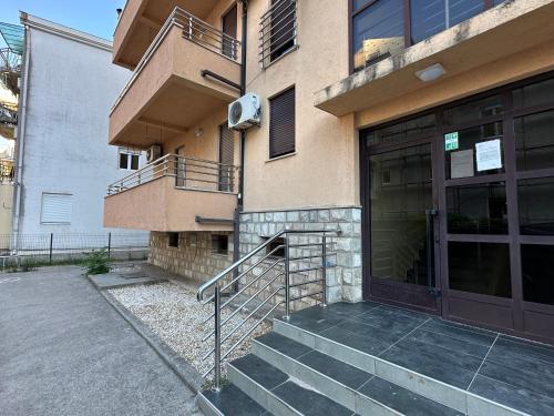 a building with a staircase next to a door at Apartment Natasa in Budva