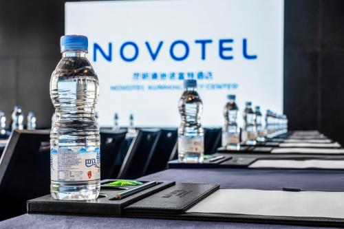a bottle of water is sitting on a table at Novotel Kunming City Center in Kunming
