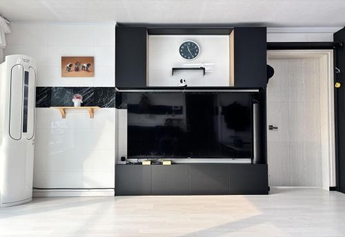 a living room with a large flat screen tv at House of Rising Sun - Nanhee House in Incheon