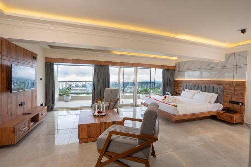 a large bedroom with a bed and a large window at Winterfeel Luxury Resort Kodaikanal in Kodaikānāl