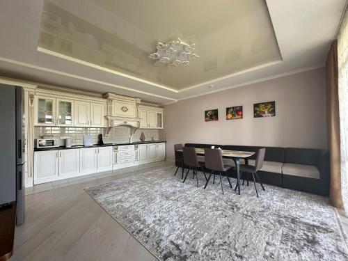 a kitchen with a table and chairs in a room at Сары-Ой Asia Palace Sky House in Chon-Sary-Oy