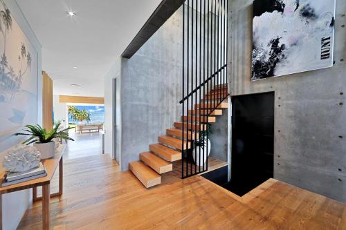 a staircase in a home with a concrete wall at Riva in Bargara