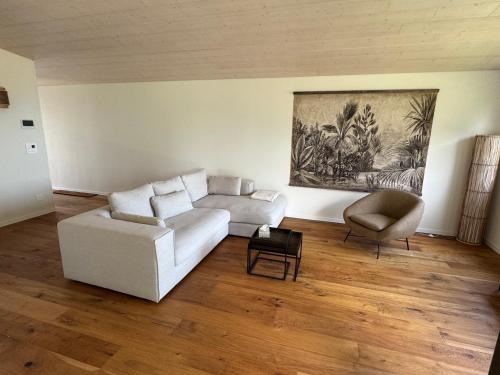 a living room with a white couch and a chair at Lodge Glardons in Marin