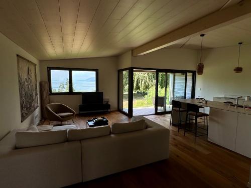 a large living room with a couch and a kitchen at Lodge Glardons in Marin
