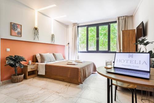 a hotel room with a bed and a laptop on a table at AEONS - Hotelia Hospitality Group in Thessaloniki