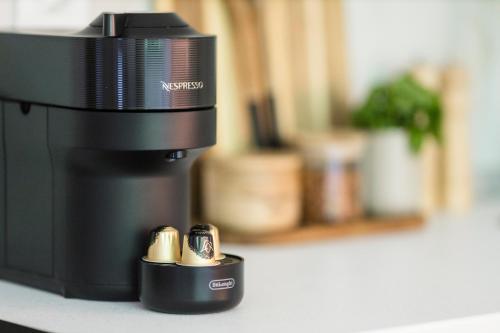 a close up of a coffee pot with two batteries at AEONS - Hotelia Hospitality Group in Thessaloniki