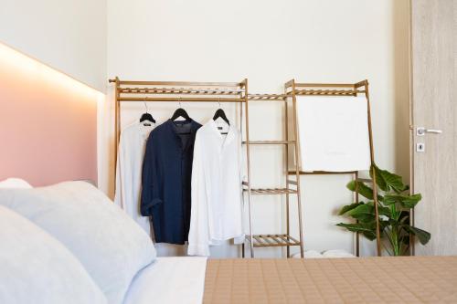 a bedroom with a clothes rack and a bed at AEONS - Hotelia Hospitality Group in Thessaloniki