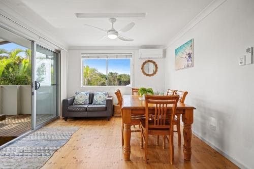 a dining room with a table and chairs at At the Beach - Lennox Head in Lennox Head