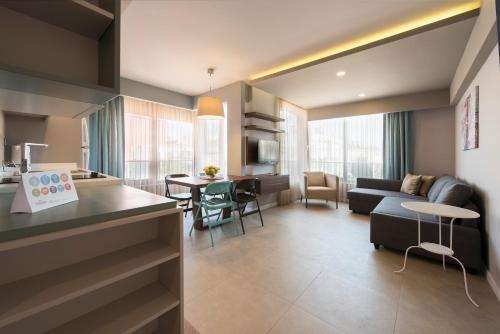 a living room filled with furniture and a large window at Trend Suites in Antalya