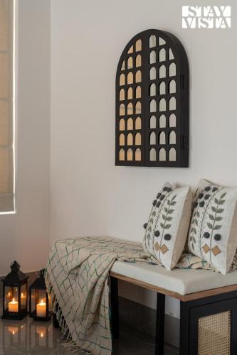 a room with a couch and a table and lights at StayVista at Casa Ti Amo with WiFi, AC, Pool, BBQ in Siolim