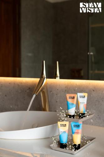 a set of four cups on a plate in a sink at StayVista at Casa Ti Amo with WiFi, AC, Pool, BBQ in Siolim