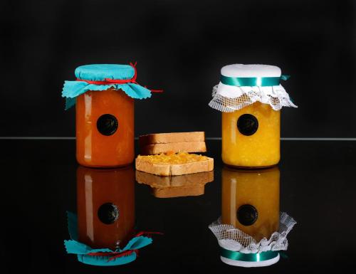 twojar bottles of honey and a piece of bread at Agriturismo Posta Pastorella in Vieste