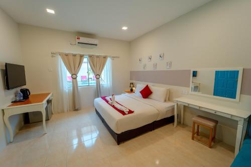 Postel nebo postele na pokoji v ubytování SANDY GARDEN RESORT LANGKAWI