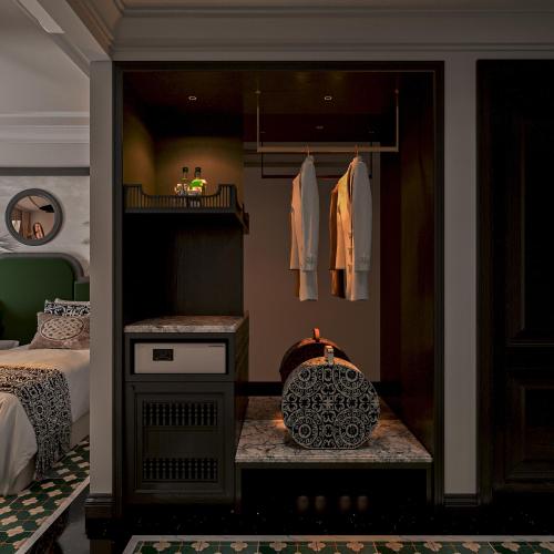a room with a bedroom with a bed and a closet at L'Heritage Riverside Hoi An in Hoi An