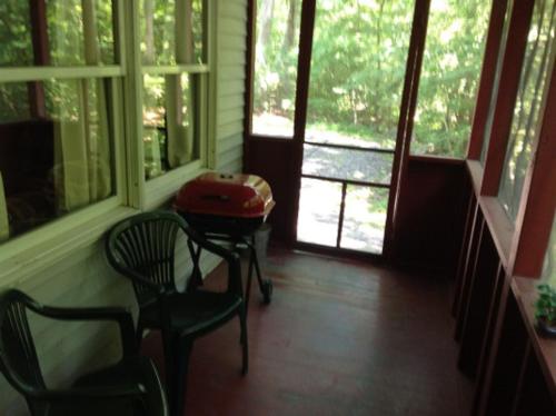 a room with two chairs and a table with a suitcase at Echo Valley Cottages in Coolbaugh
