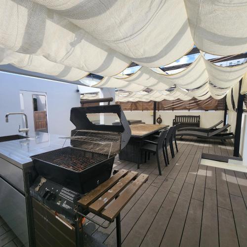 a deck of a boat with a grill and a table at 3ベッド3バス ヴィラアパラギ宮古島 in Miyako Island