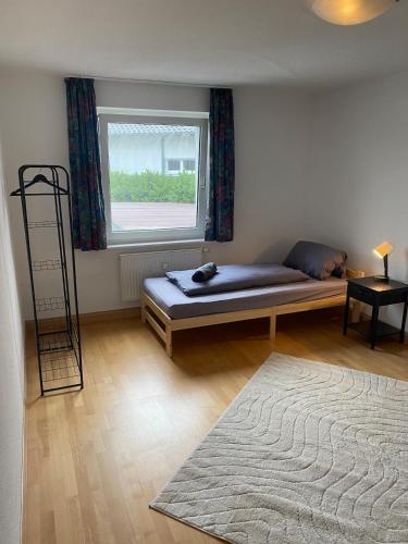 a room with a bed and a window and a rug at Monteurswohnung Albbruck in Albbruck