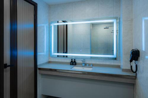 a bathroom with a sink and a mirror at iCom Blue Seaview in Maafushi