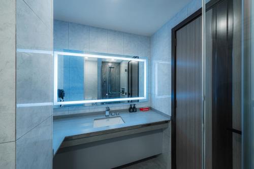 a bathroom with a sink and a mirror at iCom Blue Seaview in Maafushi