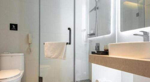 a bathroom with a sink and a toilet at Zhuhai Dehan Hotel in Zhuhai