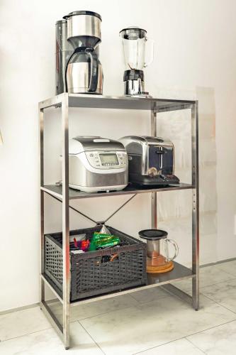 a shelf with a toaster and a blender on it at Pencil House - 10 mins walk to Shinjuku in Tokyo