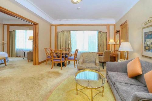 a living room with a couch and a table at Regency Hotel in Shantou