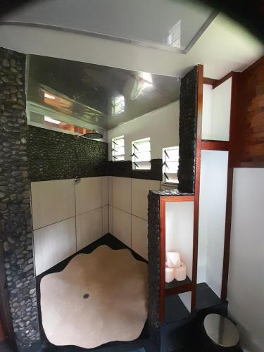 a bathroom with a large mirror in a room at Shell House with Ocean View in Savusavu