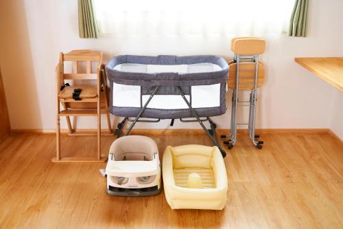 a room with a bed and a childs toy at 貸切 KIX 25min Family-Friendly Hinoki House Free P in Kishiwada