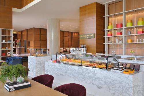 a bakery with a counter with many pastries on it at Rosewood Abu Dhabi in Abu Dhabi