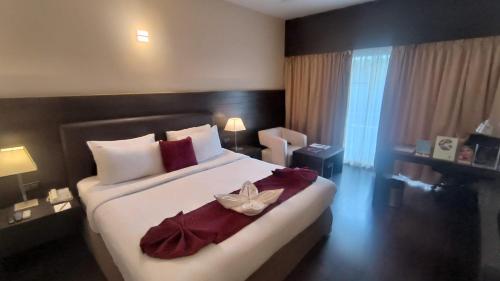 a bedroom with a large bed with a flower on it at THE WOODROSE in Bengaluru