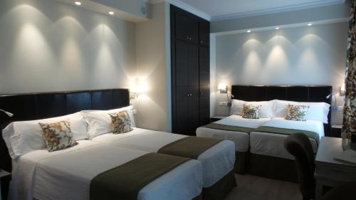 Una cama o camas en una habitación de Hotel Moderno Puerta del Sol