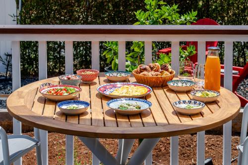 a wooden table with bowls of food on it at פינה בנחלה in Sede Eli‘ezer