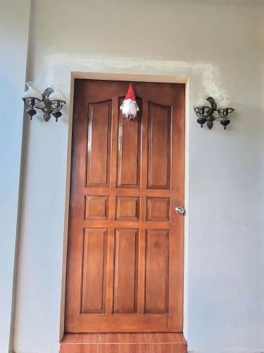 a wooden door with a santa hat on it at Jvc Zel transient house in Daraga