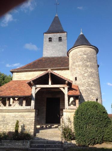 a church with two towers on top of it at Logis Auberge De La Plaine in La Rothière