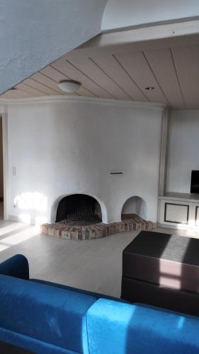 a living room with a couch and a fire place at Hotel Aurbacher Hof GmbH in Munich