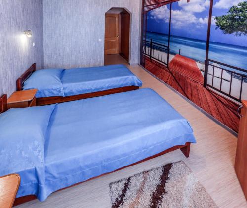 two beds in a room with a view of the ocean at Private Residence Osobnyak in Odesa