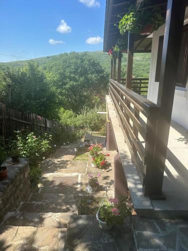 a view from the porch of a house with flowers at La Colonelu in Sărata-Monteoru
