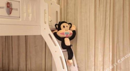 a stuffed monkey is hanging on a door at Xian Jue Vu Hotel in Xi'an