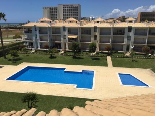 an aerial view of a large apartment building with a swimming pool at Beach Apartment Vilamoura Villa Columbus in Vilamoura