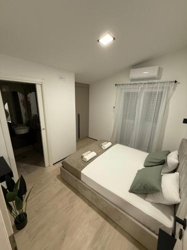 a bedroom with a large bed and a window at Casa Verde in Donji Zemunik