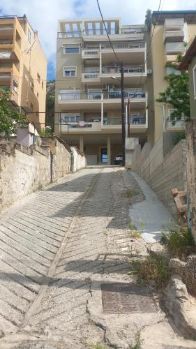 an empty street in front of a building at Sofia's Apartment in Kavala