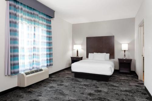 a hotel room with a bed and a window at La Quinta by Wyndham Columbus - Edinburgh in Columbus