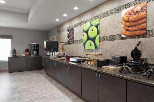 a kitchen with a counter with some food on it at La Quinta by Wyndham Columbus - Edinburgh in Columbus