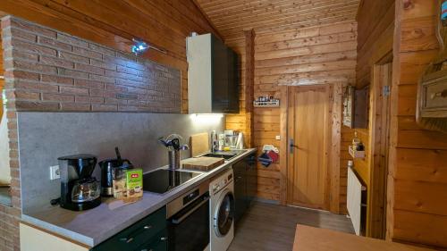 a kitchen with a sink and a stove top oven at kuscheliges Waldhaus Kaminknistern in Oldendorf